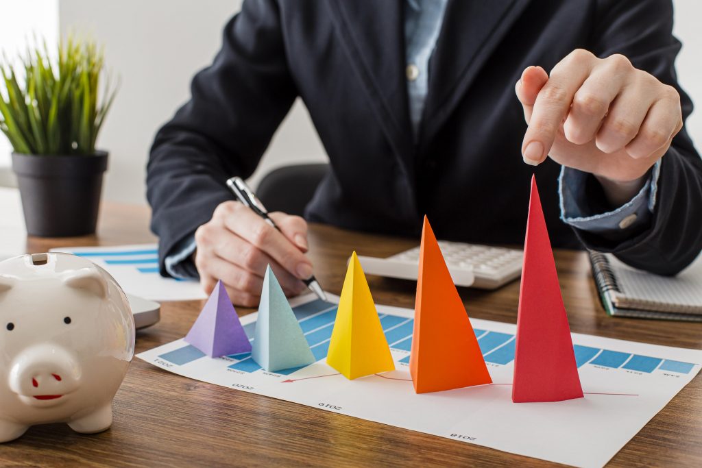 businessman with colorful cones representing growth